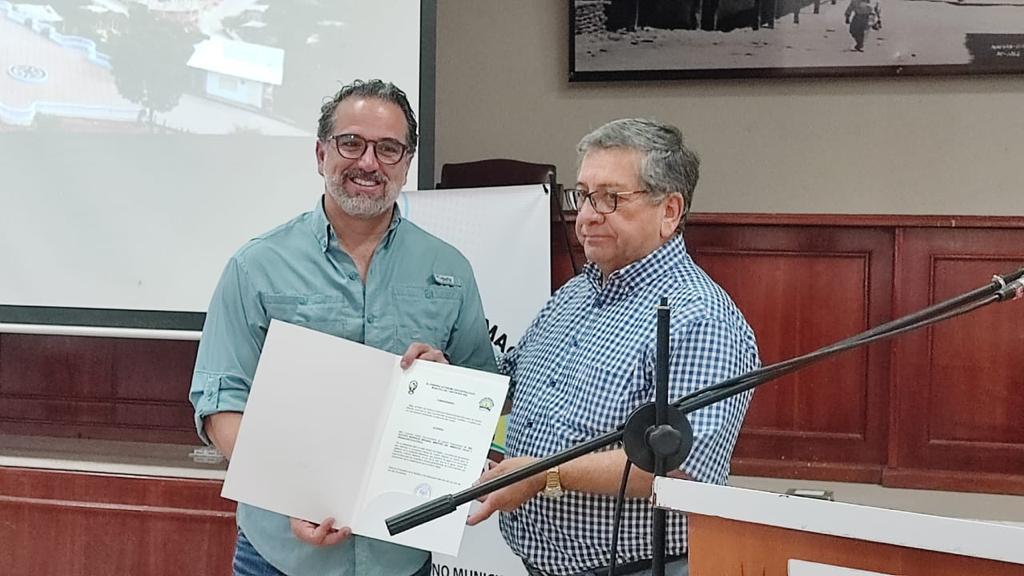 El alcalde de Macará, Alfredo Suquilanda, entrega al ministro del Ambiente, Gustavo Manrique Miranda, un acuerdo de reconocimiento por su visita.