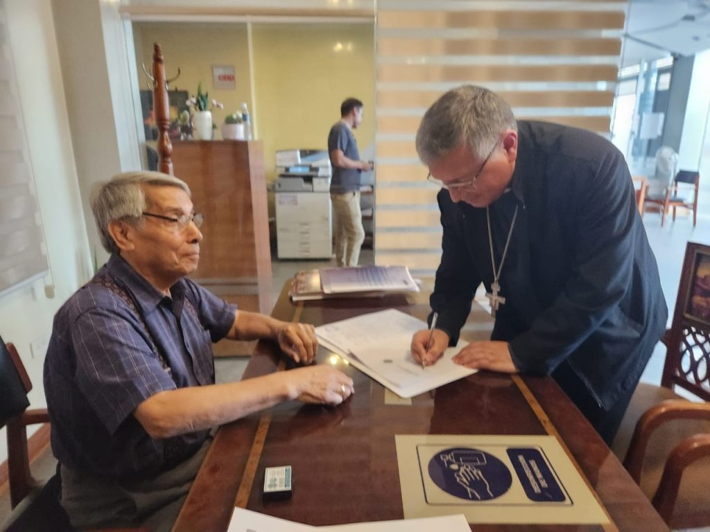 El Obispo de la Diócesis, Monseñor Walter Heras Segarra, firma las escrituras públicas ante un notario de Catamayo.